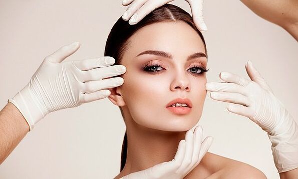 Glove hands on the girl's face